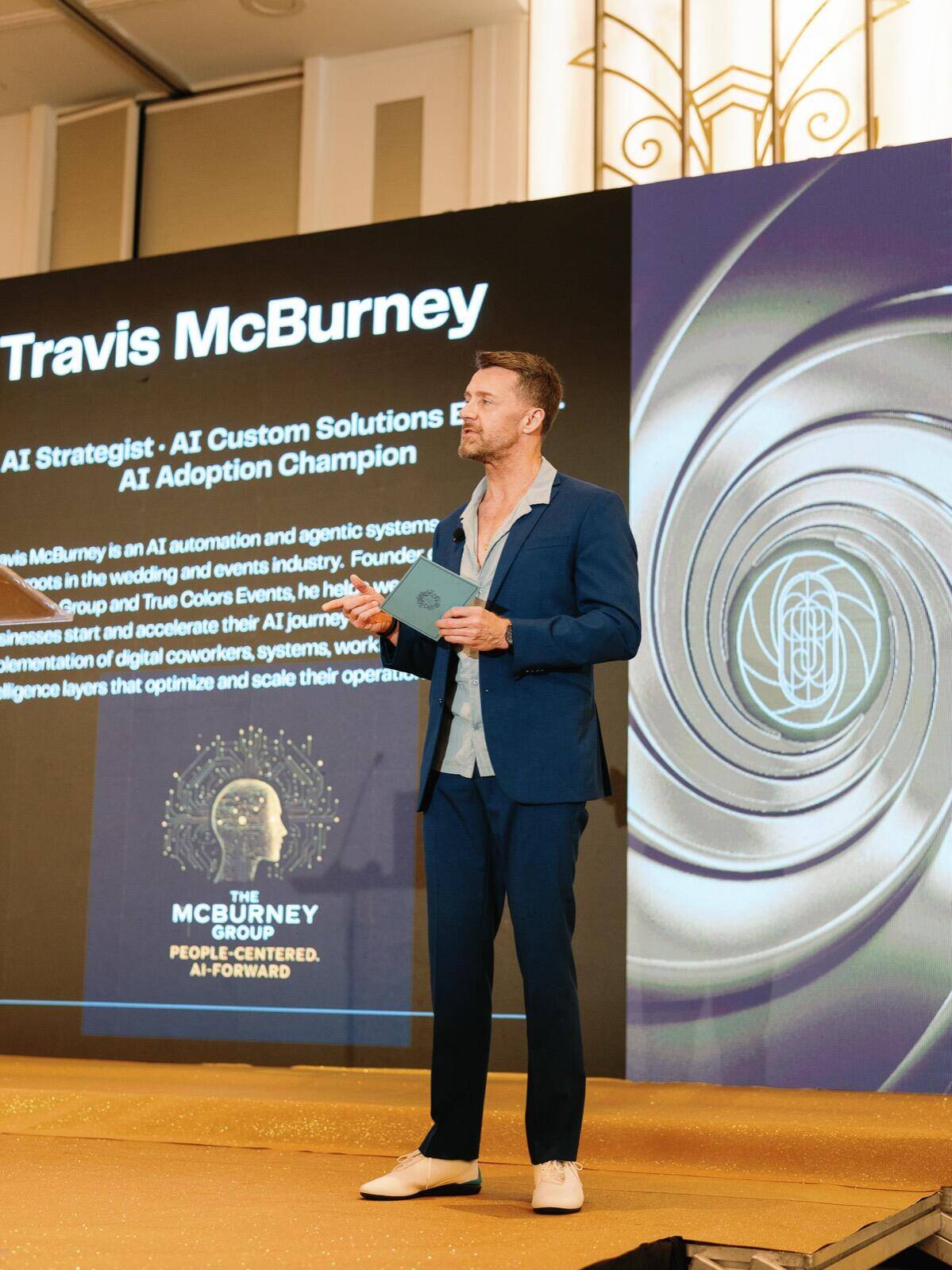 Travis McBurney speaking on stage at RSVP conference