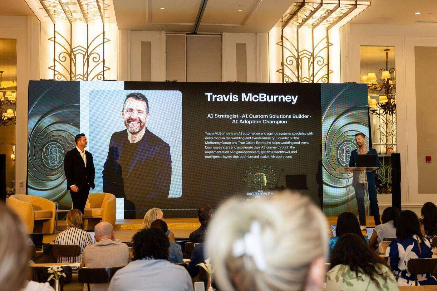 Travis McBurney on stage at RSVP conference, full room view